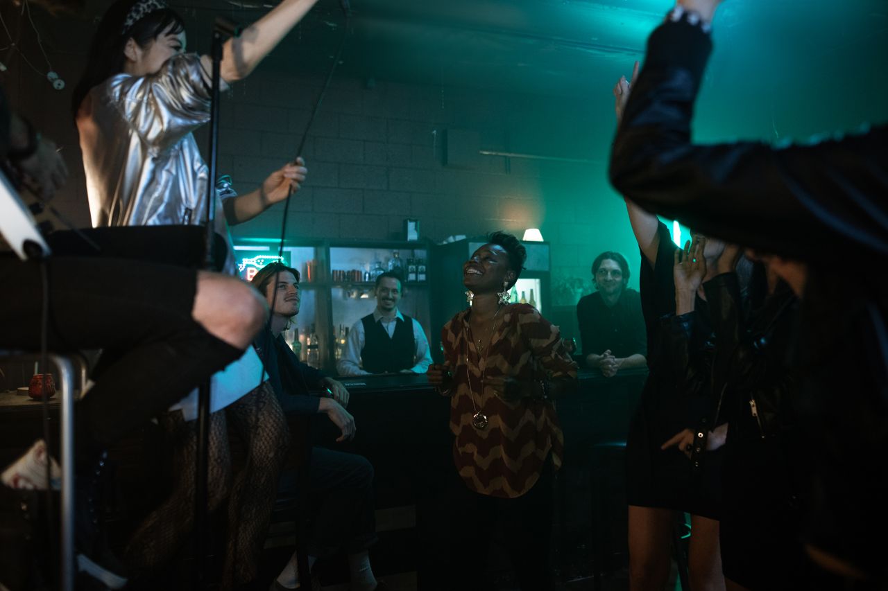 Vibrant nightlife scene with people enjoying music and dancing at a lively bar.